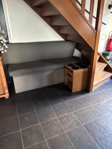 a bench under the stairs in a kitchen at Christinahoeve Logies in Boskoop