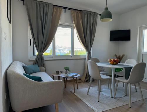 a living room with a couch and a table at Apartman Domnius in Škrip