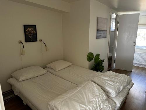 a bed in a bedroom with two pillows on it at Hällestrand Seaview Apartment in Strömstad