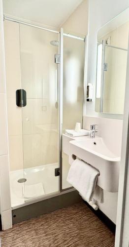 a bathroom with a shower and a sink at B&B HOTEL Lille Centre Grand Palais in Lille