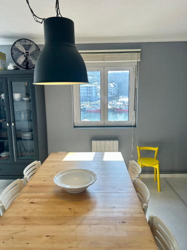 a dining room with a wooden table with a plate on it at La Rula in Luarca