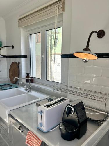 a kitchen with a toaster on a counter next to a sink at La Rula in Luarca