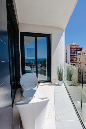 a bathroom with a tub and a toilet on a balcony at Calpe Beach Arenal Bol View in Calpe