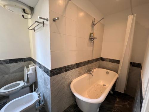 une salle de bain avec toilettes et baignoire dans l'établissement Charming Vintage Flat only 1 min walk from Monte Carlo, à Beausoleil