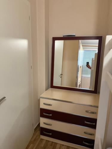 a bathroom with a dresser with a mirror on it at Studio holidays in Shëngjin