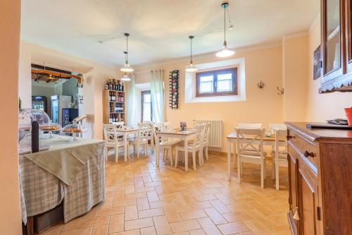a kitchen and dining room with tables and chairs at Masseria del bosco Poderuccio in Chianciano Terme