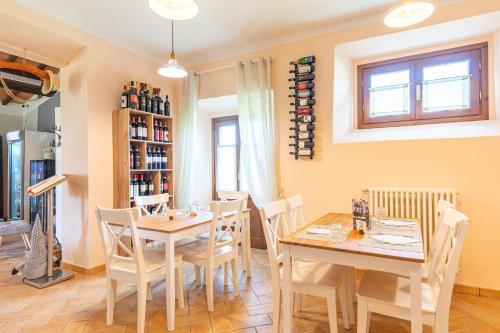 a dining room with a table and chairs at Masseria del bosco Poderuccio in Chianciano Terme