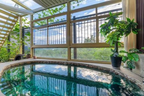 a swimming pool in a house with a large window at Gubei Water Town Landscape Villa in Miyun