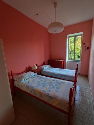 a bedroom with two beds and a window at Appartamenti vistAmare - Casacromia - in Vibonati