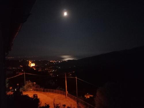 a full moon over a city at night at Appartamenti vistAmare - Casacromia - in Vibonati