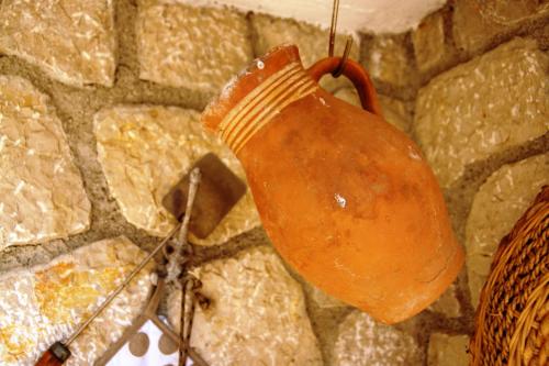 a clay pot hanging on a stone wall at Apartments Dvorski in Mandre
