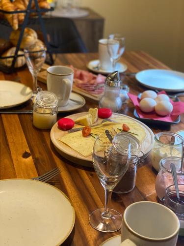 特伦德尔堡Gast- und Pensionshaus Pilgereck的一张木桌，上面放着盘子和酒杯