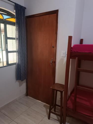 a door to a room with a bunk bed at Hostel do Papai 3 in Lavras