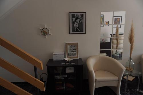 a living room with a chair and a staircase at Guesthouse Villa Stanger 2 in Lovran