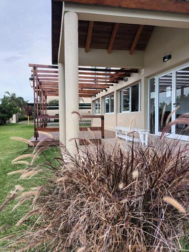 a house with some plants in front of it at Brisas del Lago Apart y Hotel in Federación