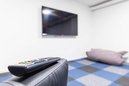 a remote control sitting on the arm of a couch at Villa Blau in Schruns-Tschagguns