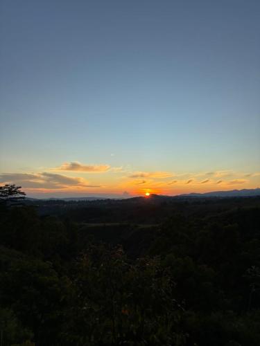 a sunset with the sun setting in the horizon at Ruteng Glamping & Campsite in Ruteng