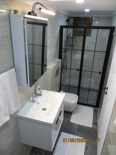 a bathroom with a white sink and a toilet at Stella Blu Apartments in Fethiye