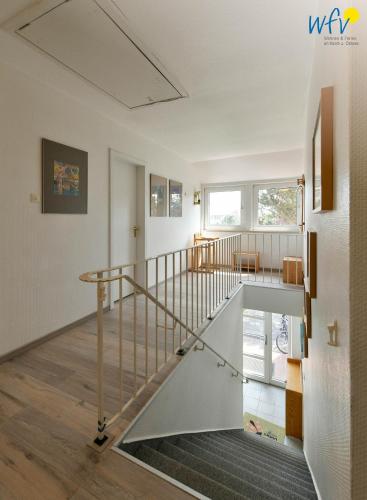 a staircase in a house with a glass railing at Ferienhaus Caterlieschen Ferienwohnung 2 in Juist