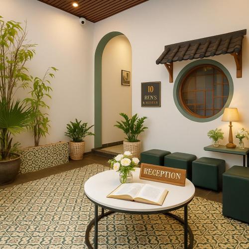 a lobby with a coffee table and a book at Ben's Premier Hotel & Apartment - Hanoi Center in Hanoi