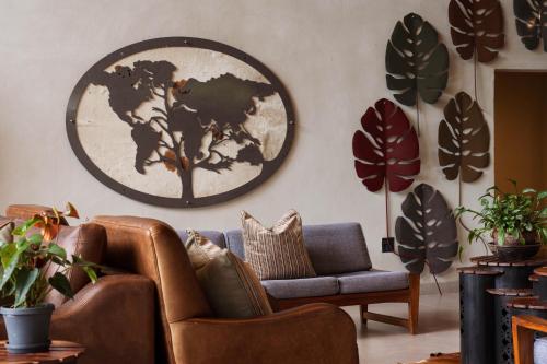 a living room with a couch and a world map on the wall at Chobe River Lodge in Kasane