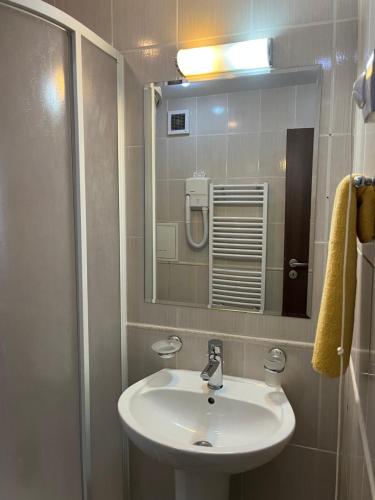 a bathroom with a sink and a mirror at All seasons club Bansko in Bansko