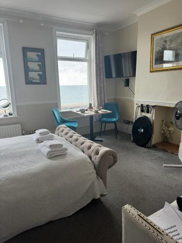a bedroom with a bed and a desk and a window at The Ship Inn - Sandgate in Folkestone