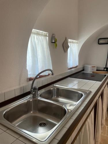 a kitchen with a sink and a window at I Trulli di Mimì in Monopoli