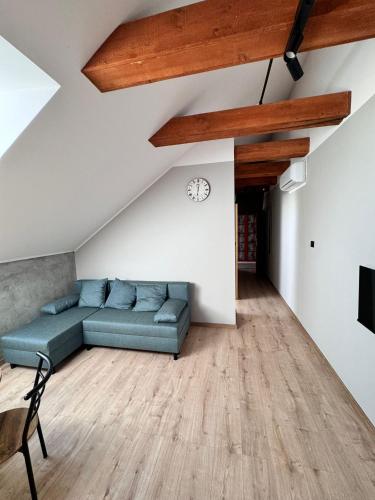 a living room with a couch and a table at Apartamenty Stodoła in Kajkowo