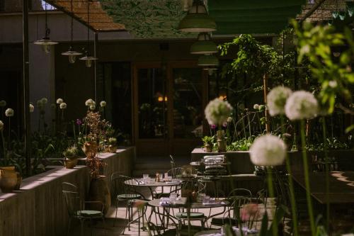 a restaurant with tables and chairs and flowers at Grand Mess Clermont-Ferrand in Clermont-Ferrand
