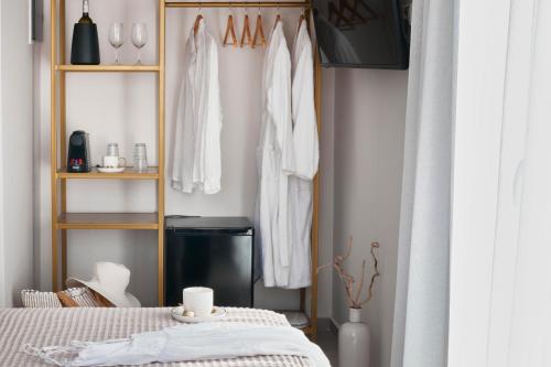 a room with a bed and a shelf with clothes at Atlas Skiathos in Skiathos Town