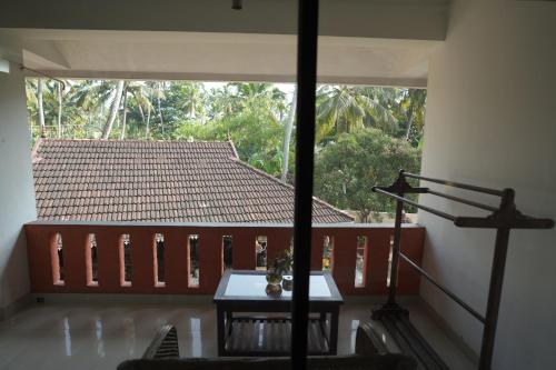 a view of a room with a table and a roof at Hotel Sunrise Kovalam in Kovalam