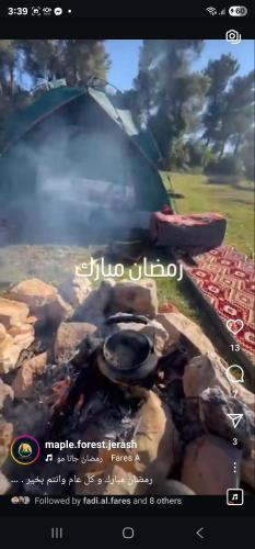 a picture of a grill with smoke coming out of it at Maple forest park cabins in Sākib