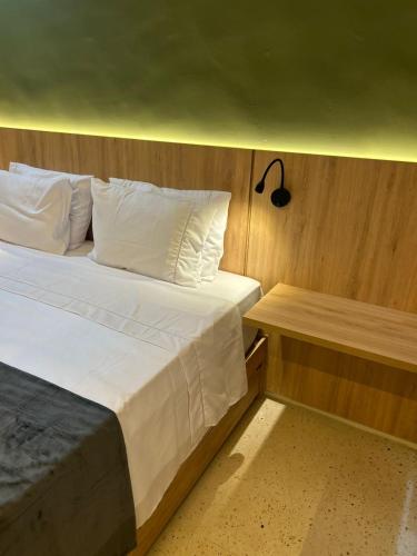 a bedroom with a large bed and a night stand at Alter Beach Flat in Alter do Chao