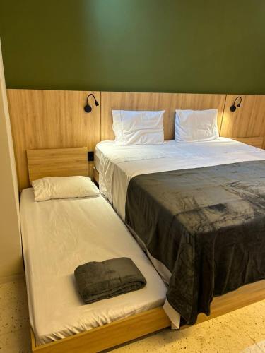 a pair of beds in a room with at Alter Beach Flat in Alter do Chao
