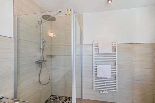 a shower with a glass door in a bathroom at Casa Fortuna in Göhren-Lebbin