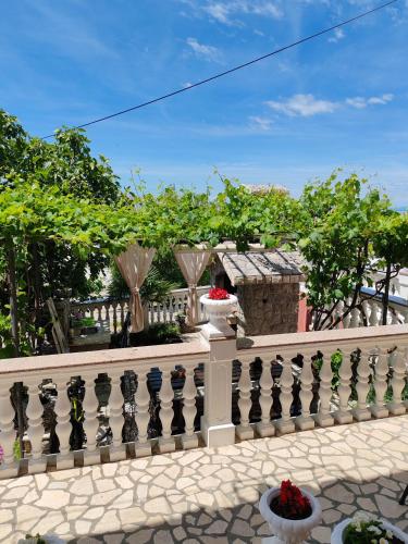 a white fence with some flowers on it at Apartment Laura in Senj