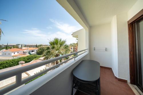 a balcony with a chair and a view of the city at Bellavista Avenida By BeGuest in Albufeira