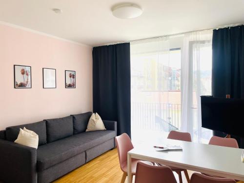 a living room with a couch and a table at APSTAY City Center I FREE Parking I Self Check-in in Graz