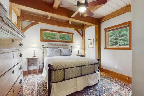 a bedroom with a bed and a ceiling fan at Splendor On The Lake in Center Harbor