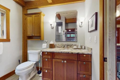 a bathroom with a toilet and a sink at Splendor On The Lake in Center Harbor