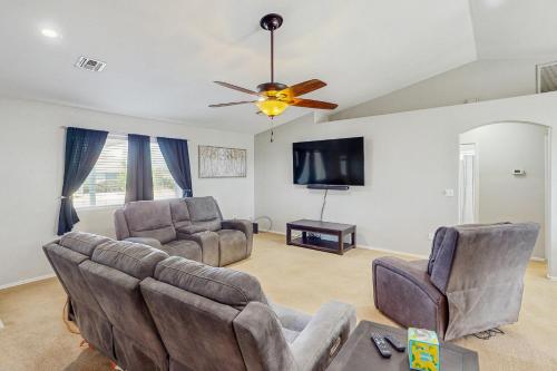 a living room with two couches and a flat screen tv at The Cozy Pines Getaway in Show Low