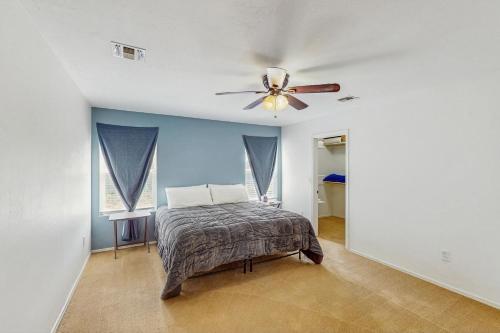 a bedroom with a bed and a ceiling fan at The Cozy Pines Getaway in Show Low