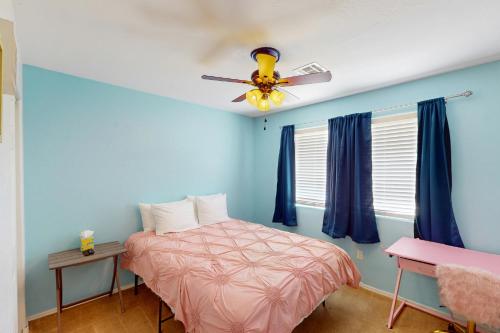 a bedroom with a bed and a ceiling fan at The Cozy Pines Getaway in Show Low