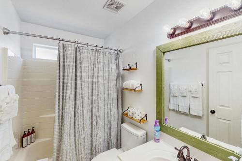 a bathroom with a toilet and a sink and a mirror at The Cozy Pines Getaway in Show Low