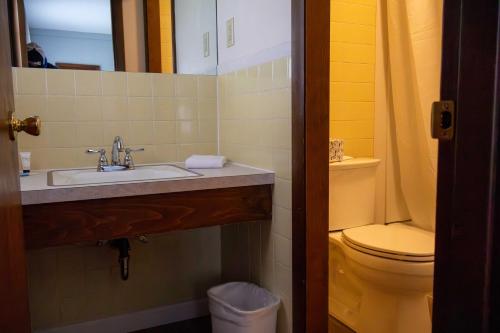 a bathroom with a sink and a toilet at 1848 Inn in Weirs Beach