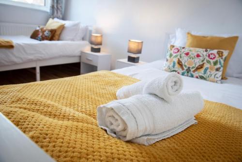 a hotel room with two towels on a bed at Pheasants Rest in Bar Hill