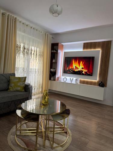 a living room with a couch and a fireplace at Newly renovated 1 bedroom Flat in Tepelenë in Tepelenë