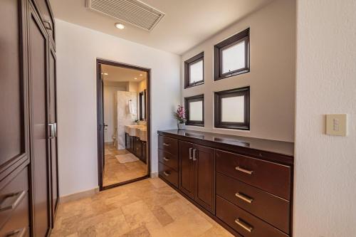 a bathroom with a wooden dresser and a mirror at Luxury Oceanfront Condo at El Caimancito Beach in La Paz