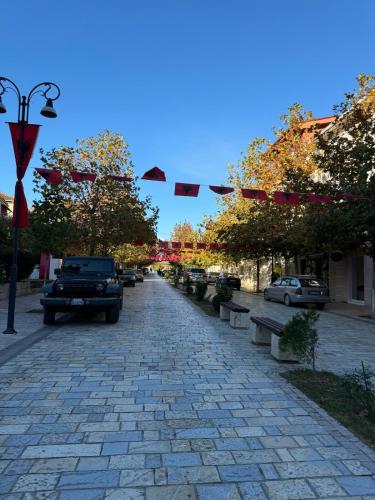 a cobblestone street with cars parked on it at Newly renovated 1 bedroom Flat in Tepelenë in Tepelenë